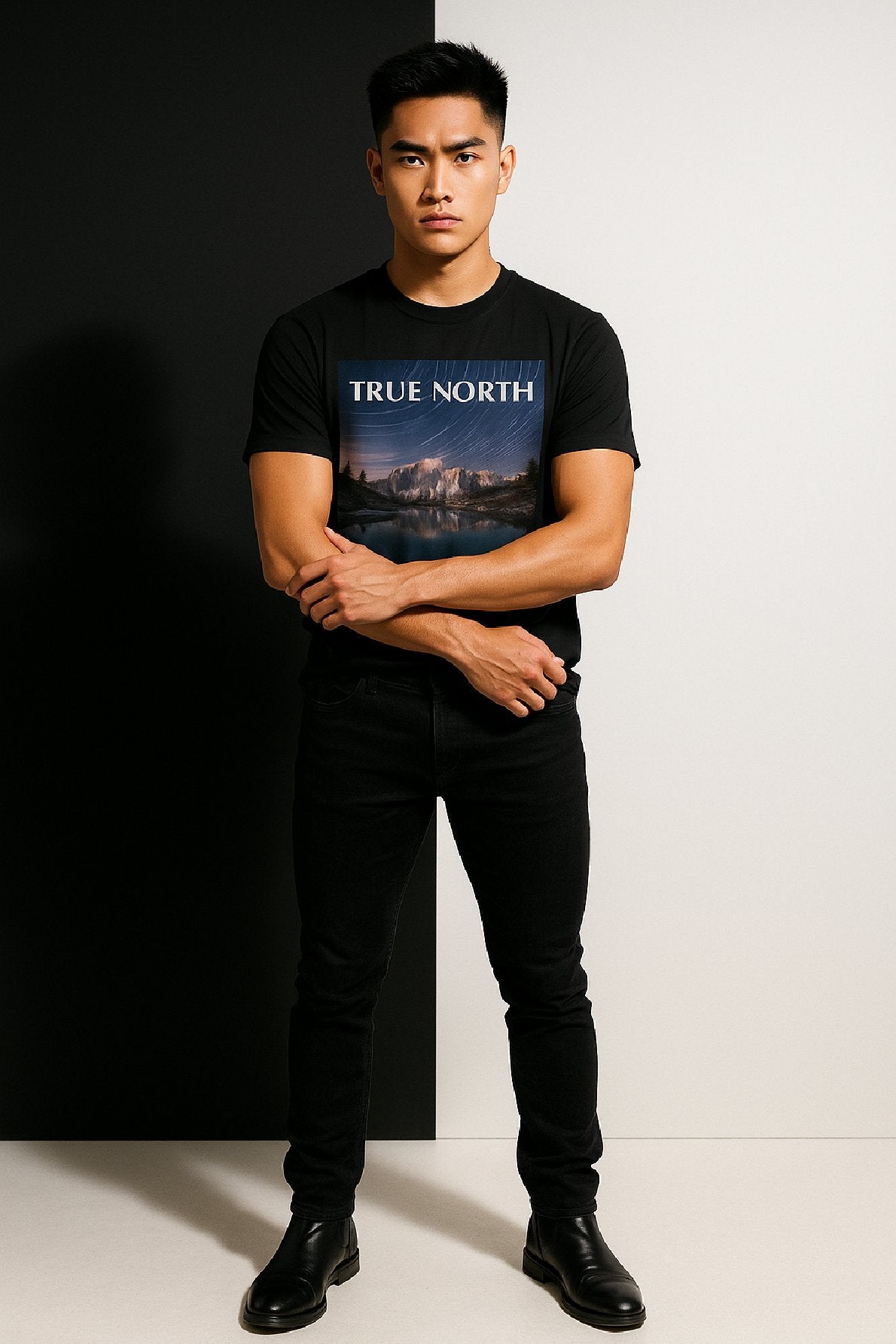 Man wearing a black t-shirt with 'True North' graphic design on a black and white background