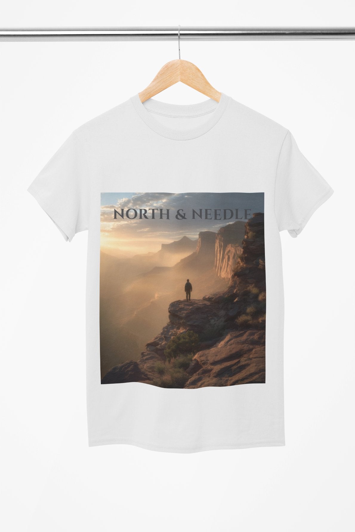 White t-shirt with a scenic print and 'North & Needle' text on a hanger.