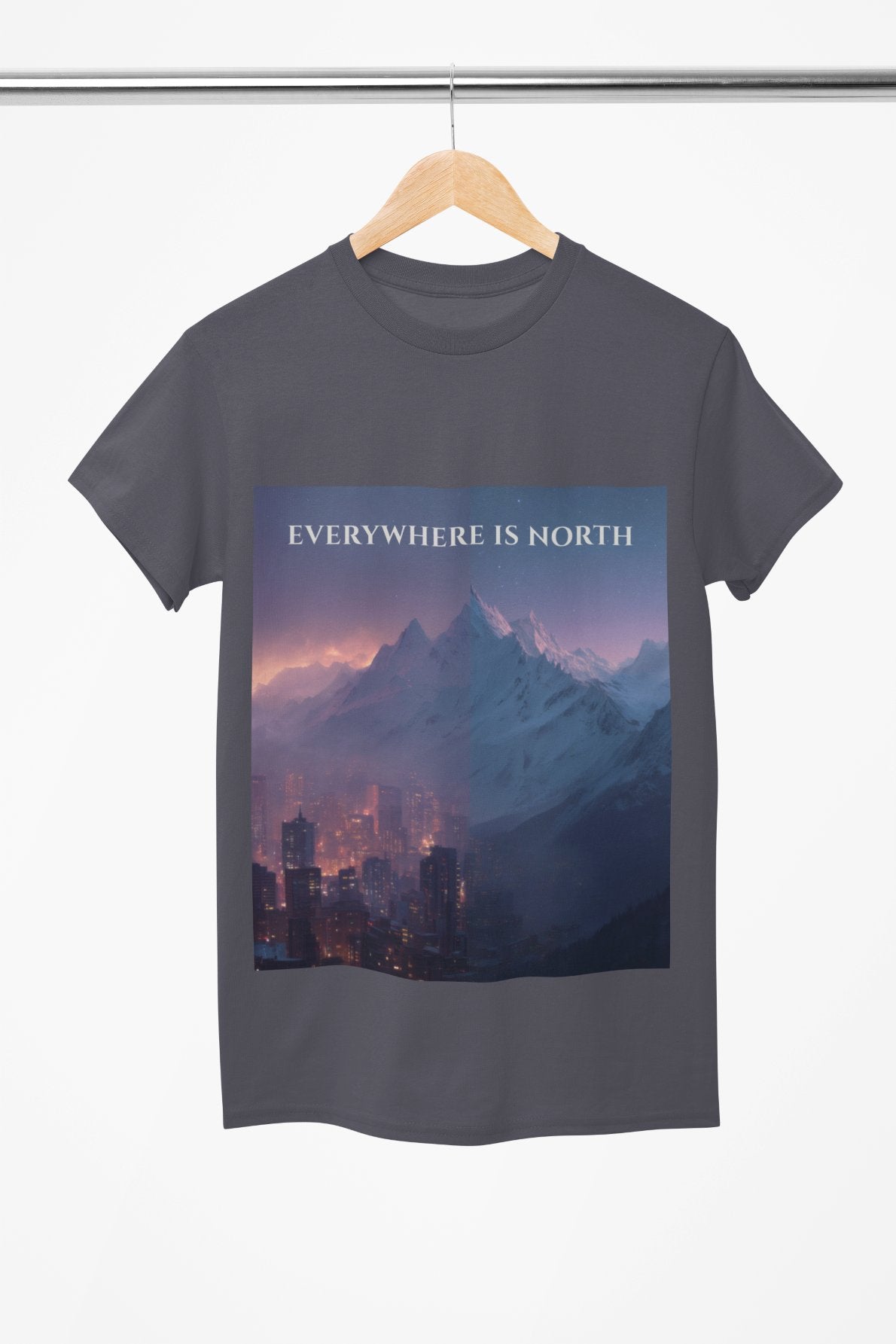 T-shirt with mountain and city design and 'EVERYWHERE IS NORTH' text on a hanger.