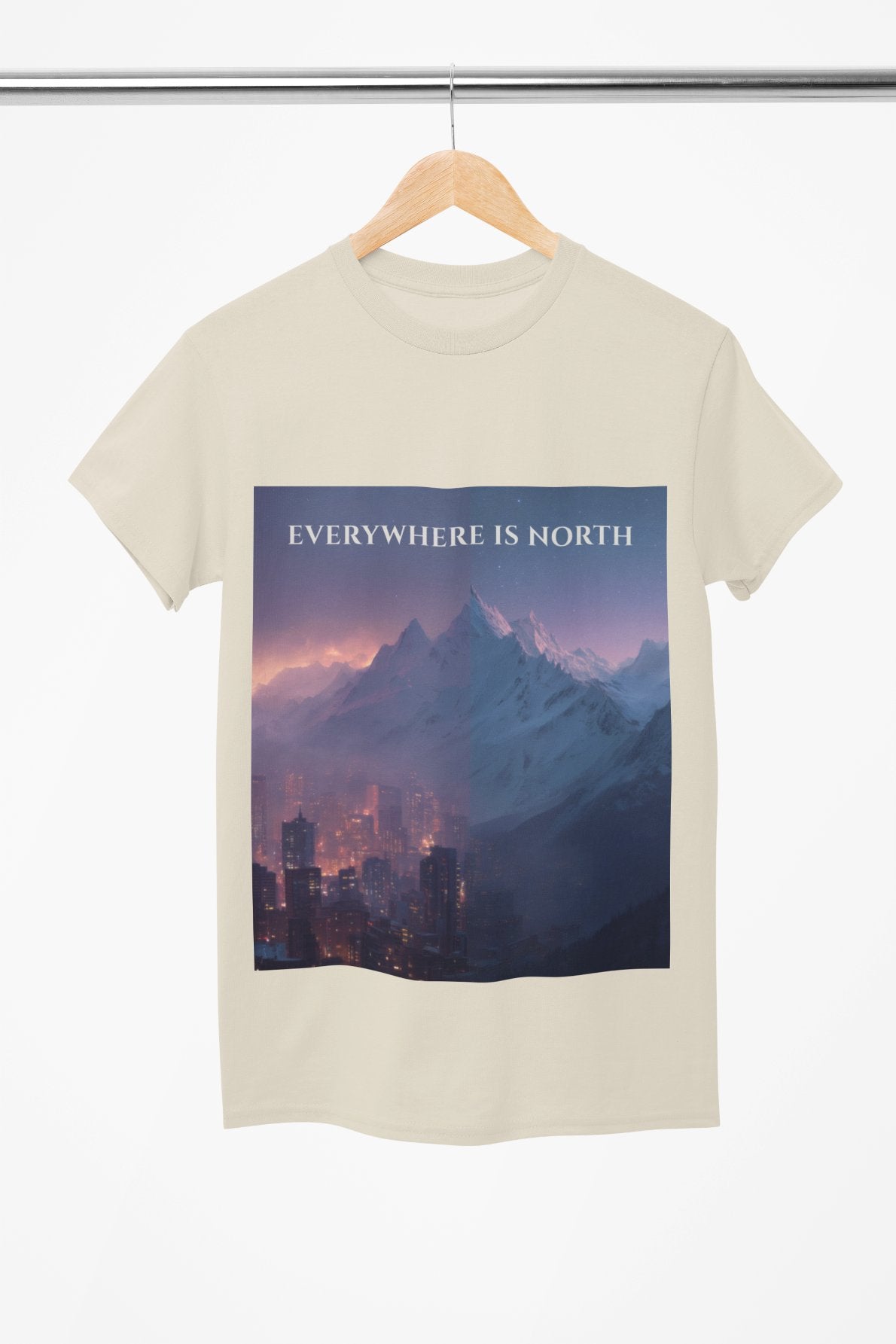 T-shirt with a mountain and cityscape design and 'EVERYWHERE IS NORTH' text on a hanger.