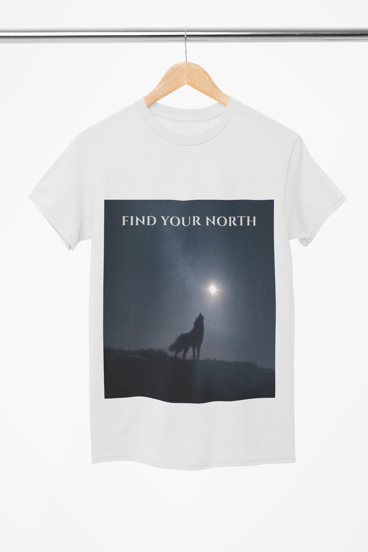 White t-shirt with a graphic of a wolf and 'Find Your North' text on a hanger.