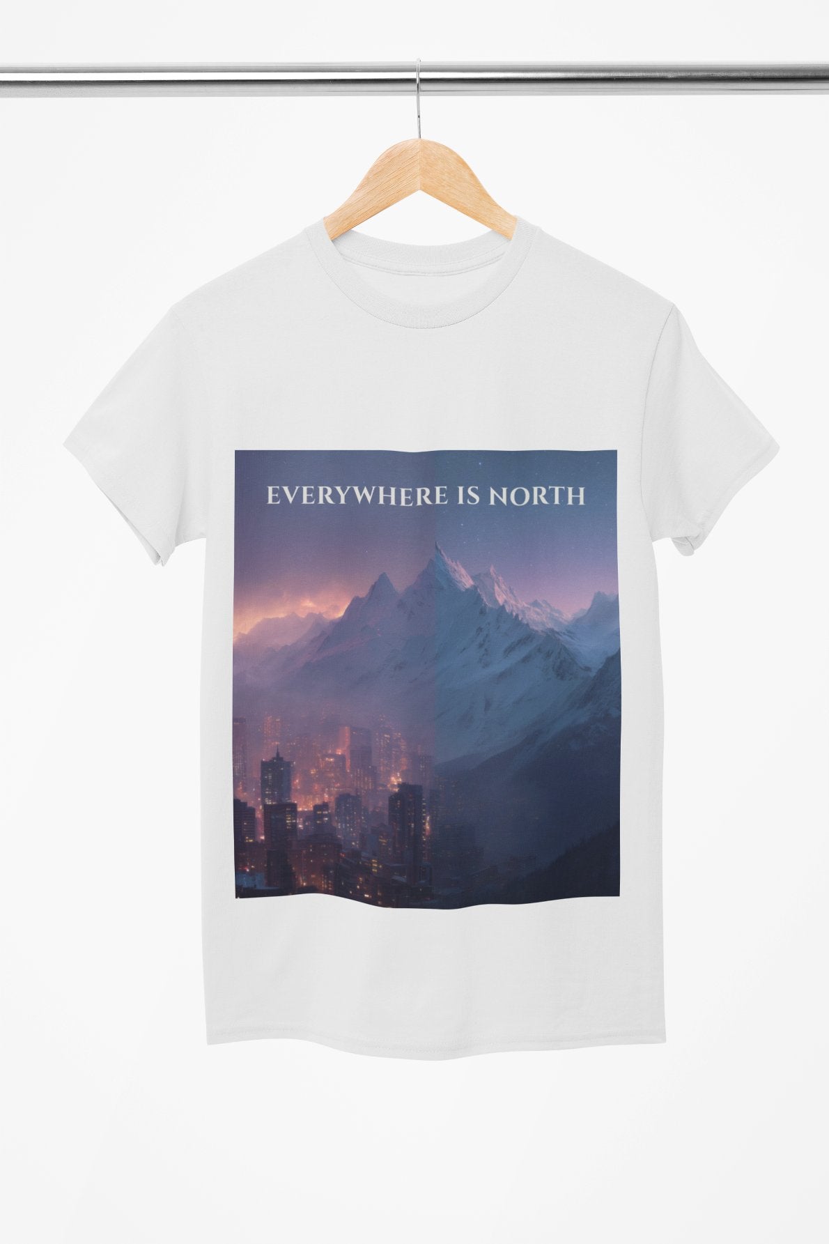 White t-shirt with a mountain and cityscape design and 'EVERYWHERE IS NORTH' text on a hanger.